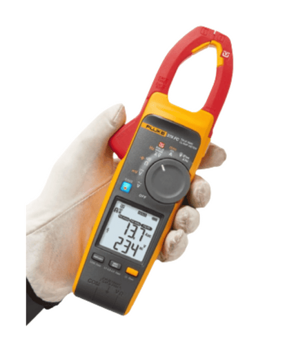 Hand holding Fluke 378 FC clamp meter